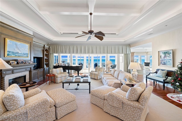 living room with coffered ceiling, ceiling fan, crown molding, hardwood / wood-style flooring, and beamed ceiling