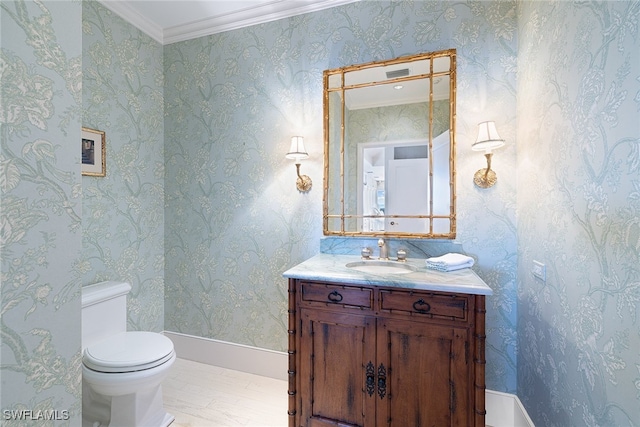 bathroom with toilet, hardwood / wood-style floors, vanity, and ornamental molding