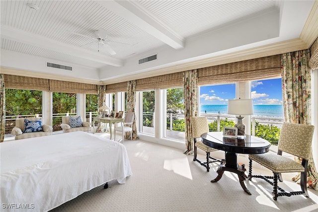 carpeted bedroom with a view of the beach, a water view, ceiling fan, and beamed ceiling