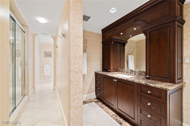 bathroom with vanity, tile patterned floors, walk in shower, and crown molding