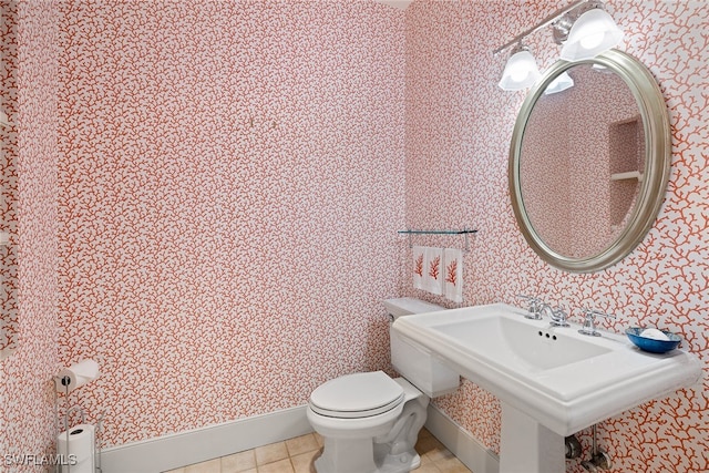 bathroom featuring tile patterned flooring and toilet