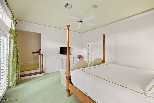 bedroom with ceiling fan, crown molding, light colored carpet, and lofted ceiling