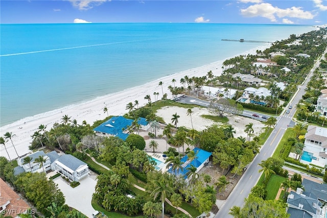 drone / aerial view featuring a beach view and a water view