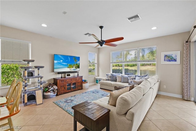 living room with ceiling fan and light tile patterned flooring