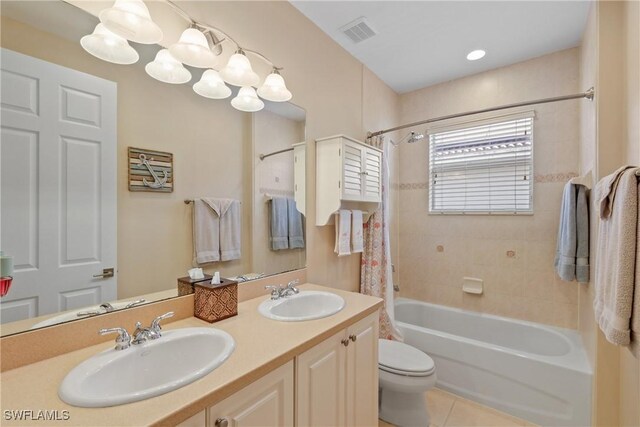 full bathroom with tile patterned floors, vanity, toilet, and shower / bath combo with shower curtain