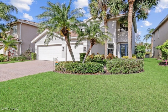 mediterranean / spanish house with a front yard and a garage