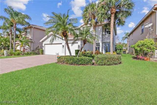 mediterranean / spanish-style home with a front lawn and a garage