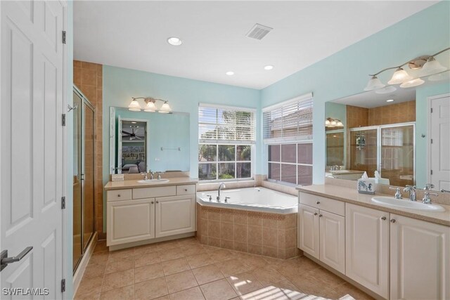 bathroom featuring tile patterned flooring, shower with separate bathtub, and vanity