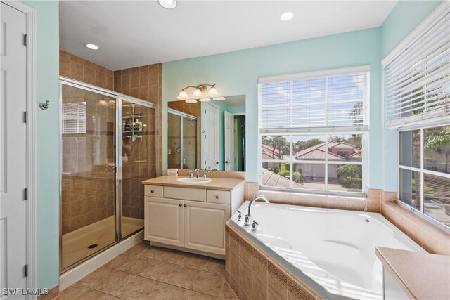 bathroom featuring tile patterned floors, separate shower and tub, plenty of natural light, and vanity