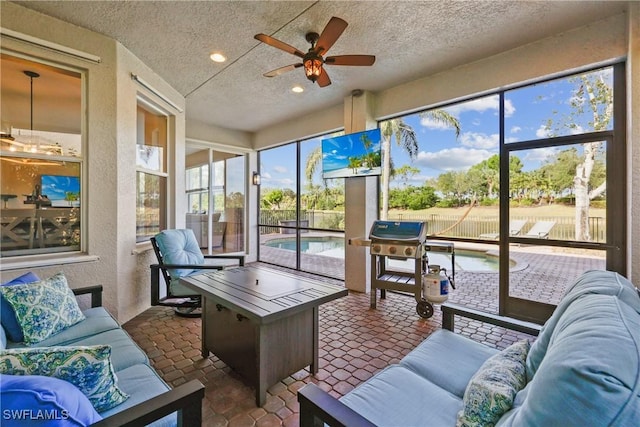 sunroom with ceiling fan