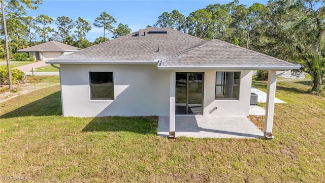 rear view of house with central AC unit, a patio area, and a lawn