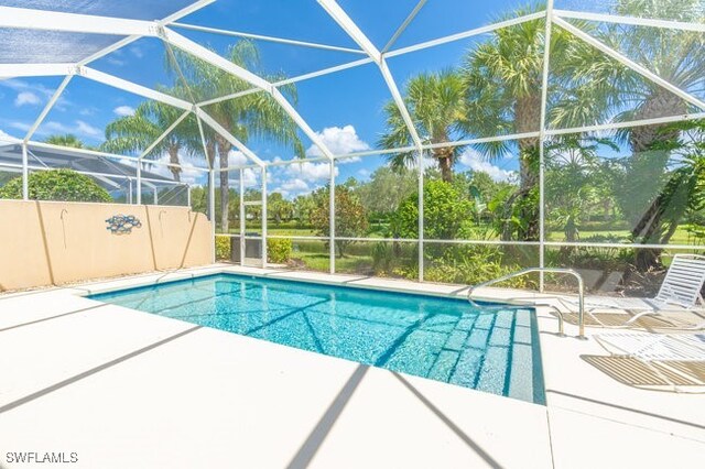 view of pool with a lanai and a patio area