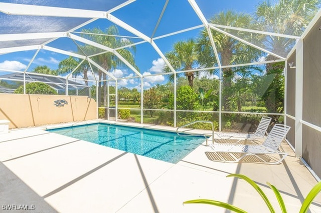 view of pool featuring a patio and glass enclosure