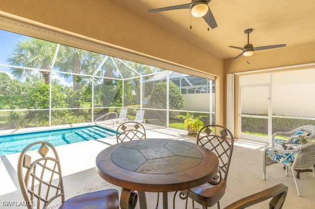 view of swimming pool with a lanai, a patio area, and ceiling fan