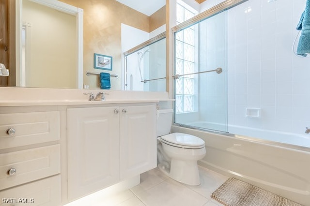 full bathroom with toilet, tile patterned flooring, vanity, and combined bath / shower with glass door