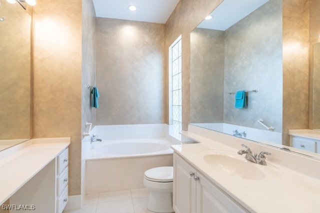 bathroom with tile patterned floors, a washtub, toilet, and vanity