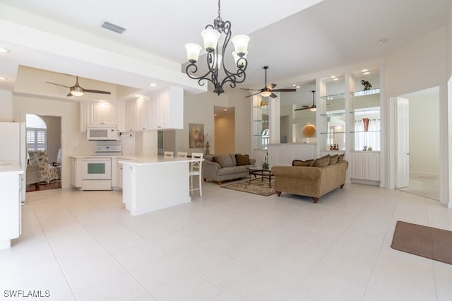 interior space featuring ceiling fan with notable chandelier