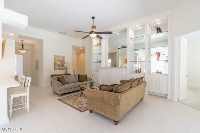 tiled living room with ceiling fan