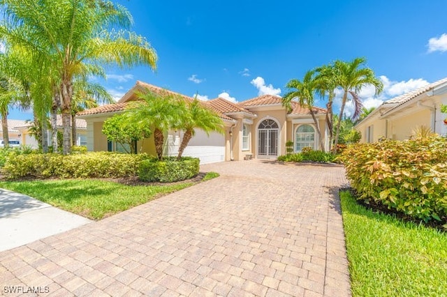 mediterranean / spanish-style home with a garage