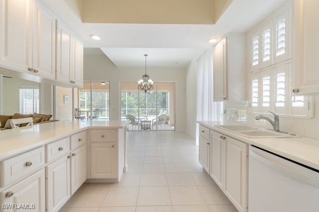 kitchen with dishwasher, decorative light fixtures, white cabinets, and sink