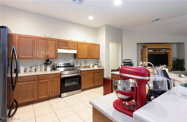 kitchen with light tile patterned floors and stainless steel appliances