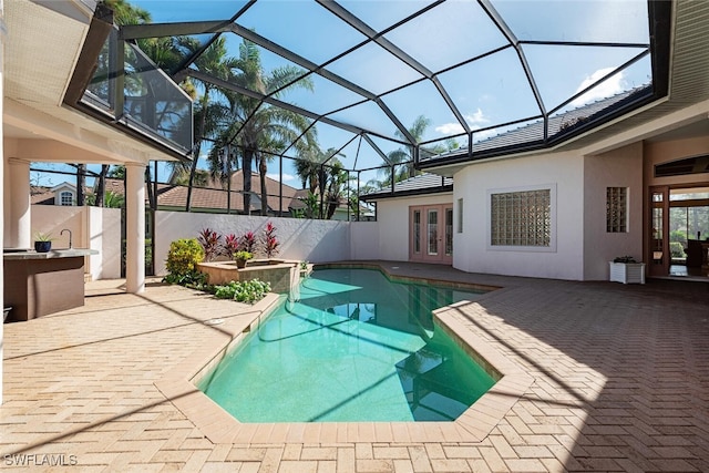 view of pool featuring a patio area, french doors, and glass enclosure