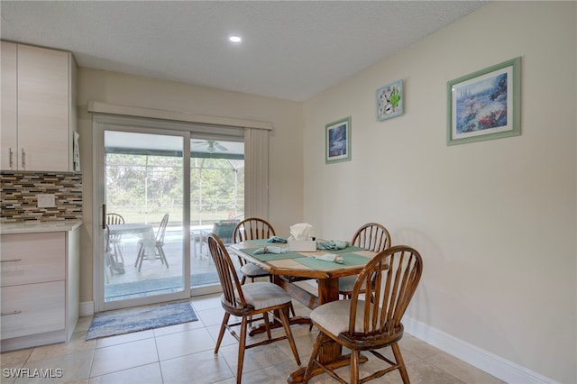 tiled dining room with a textured ceiling