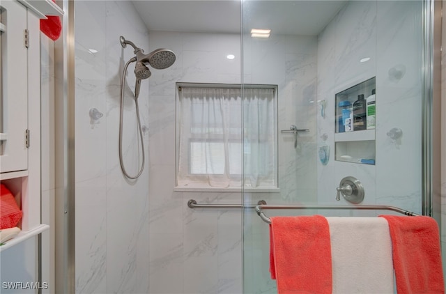 bathroom featuring a shower with door