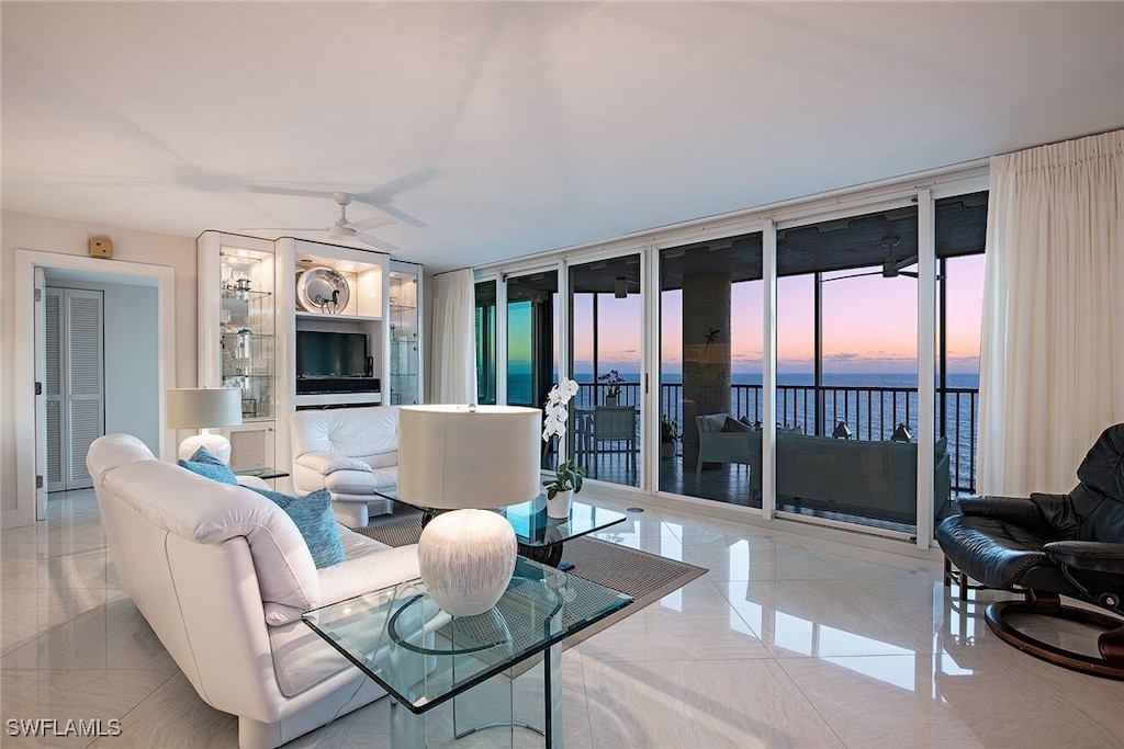 living room featuring light tile patterned floors and ceiling fan