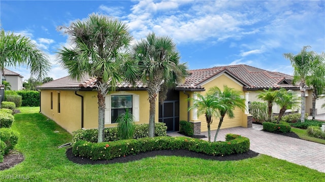 mediterranean / spanish-style home with a front yard