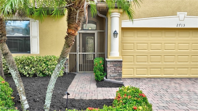 doorway to property with a garage