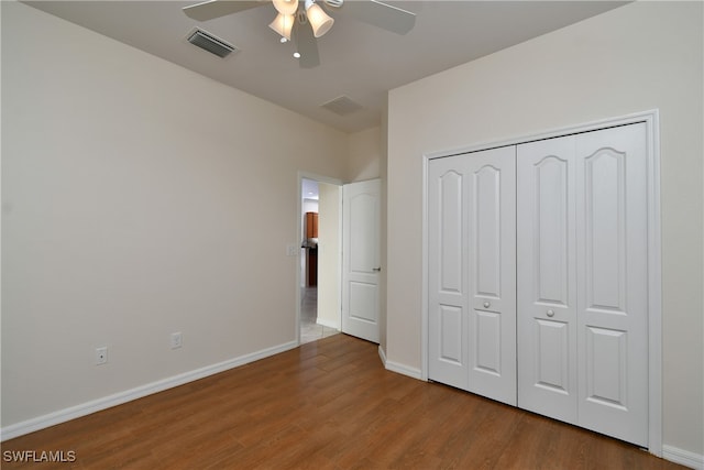 unfurnished bedroom with a closet, hardwood / wood-style floors, and ceiling fan