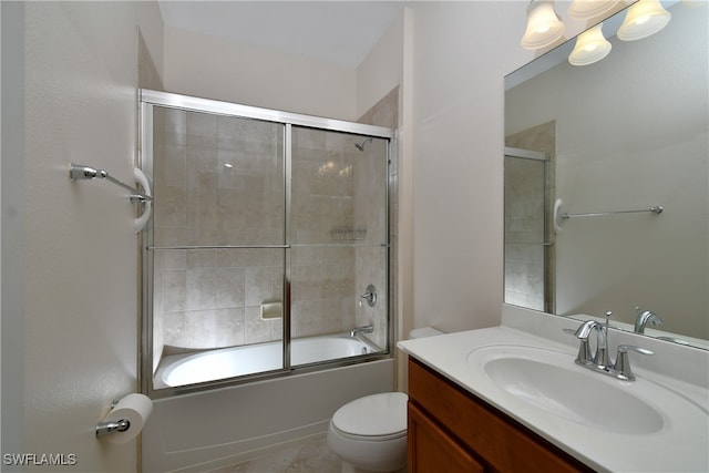 full bathroom with vanity, bath / shower combo with glass door, and toilet