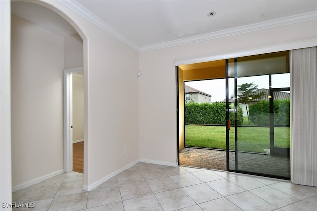 doorway with ornamental molding and light tile patterned floors