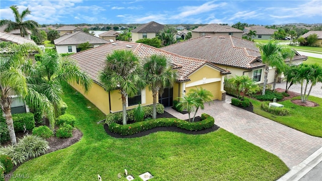 view of front of house with a garage and a front lawn