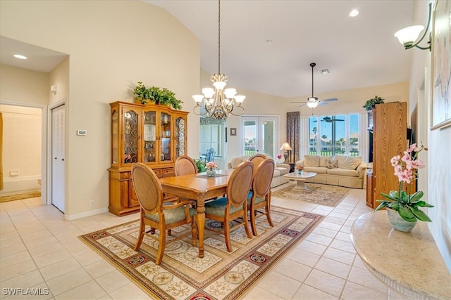 dining room with ceiling fan with notable chandelier, high vaulted ceiling, and light tile patterned flooring