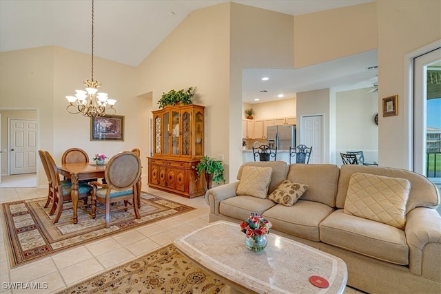 living room with light tile patterned floors, high vaulted ceiling, and an inviting chandelier