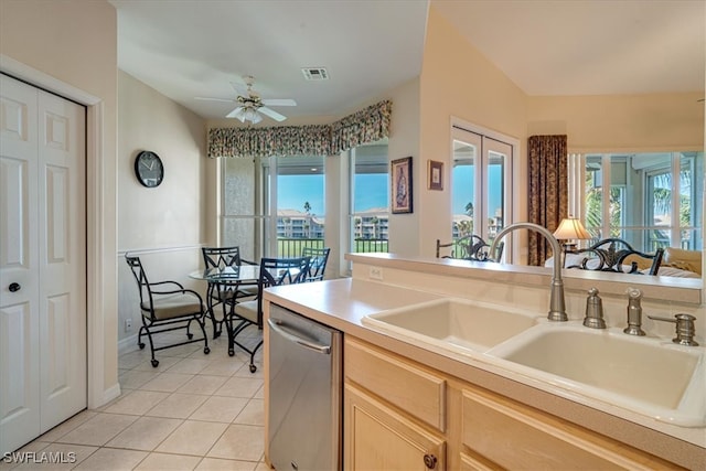 kitchen with light brown cabinetry, ceiling fan, sink, dishwasher, and light tile patterned flooring