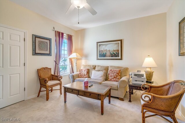 carpeted living room with ceiling fan