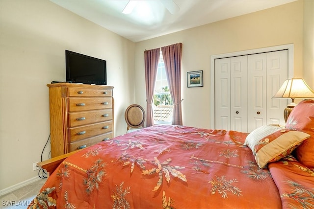 bedroom with ceiling fan, carpet floors, and a closet