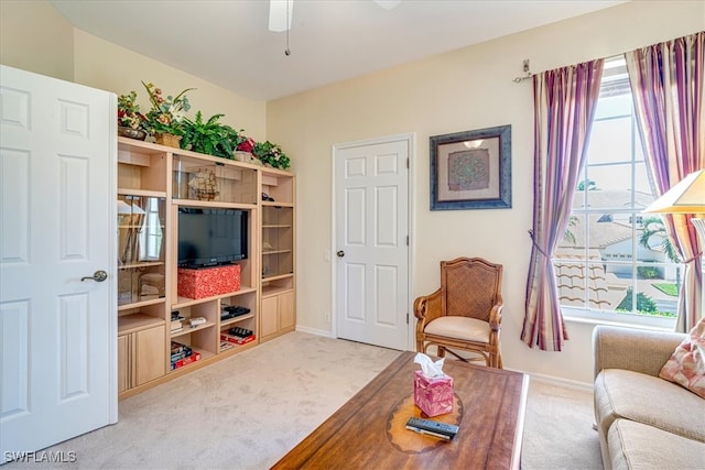 living room with ceiling fan and light colored carpet