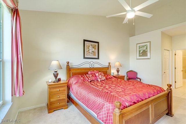 carpeted bedroom with ceiling fan, a closet, and vaulted ceiling