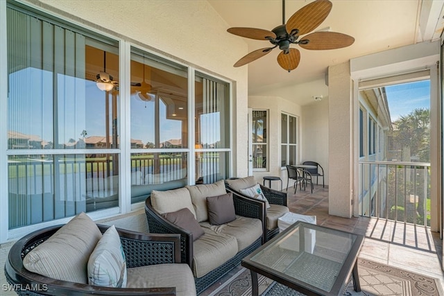 sunroom featuring ceiling fan and lofted ceiling