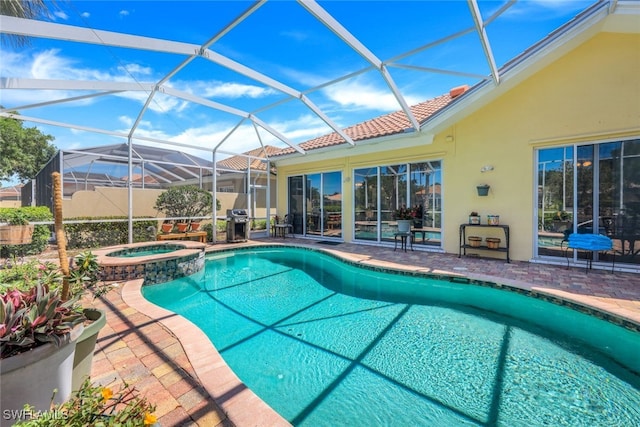 view of swimming pool with a lanai, a patio area, an in ground hot tub, and area for grilling