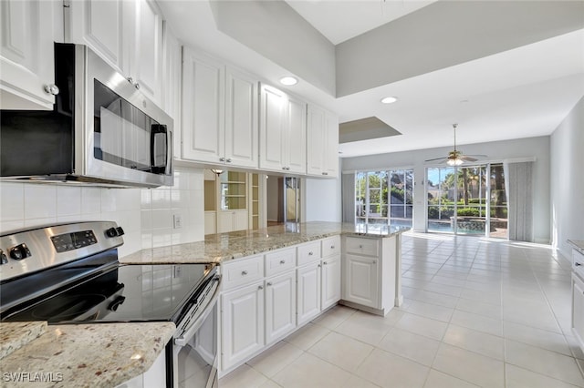 kitchen featuring ceiling fan, stainless steel appliances, backsplash, kitchen peninsula, and white cabinets