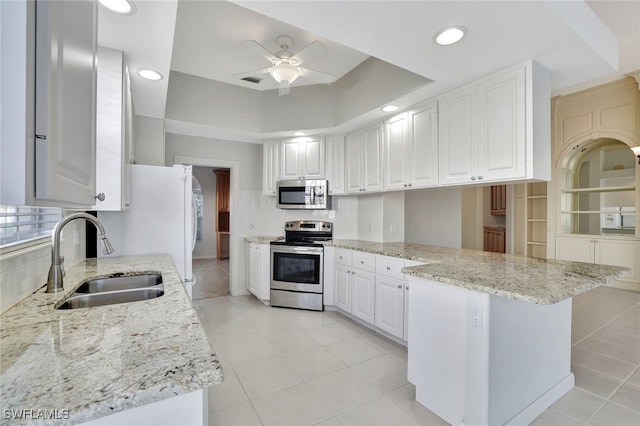 kitchen featuring light stone counters, white cabinetry, sink, and appliances with stainless steel finishes