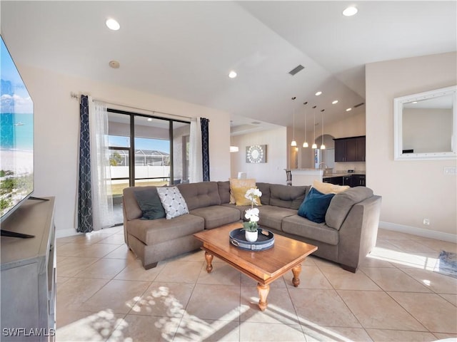 living room featuring lofted ceiling and light tile patterned floors