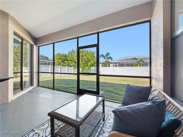 sunroom featuring lofted ceiling