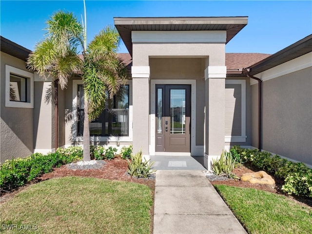 doorway to property featuring a lawn