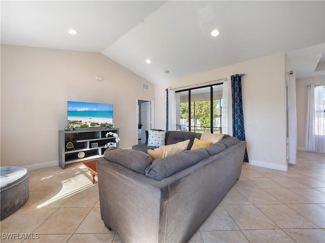 living room featuring vaulted ceiling, plenty of natural light, and light tile patterned flooring